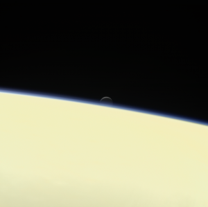 Enceladus sets behind Saturn