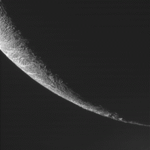 Cassini views the moon Enceladus passing in front of Saturn