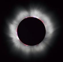 The Sun's corona shines around the intervening Moon during a total solar eclipse