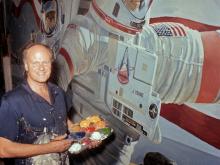 Robert McCall works on a space mural