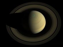 Saturn, its rings, and a hexagonal storm at its north pole, 2013