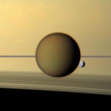 The moons Titan and Dione in front of Saturn