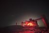 The IceCube neutrino observatory under a night sky at the south pole